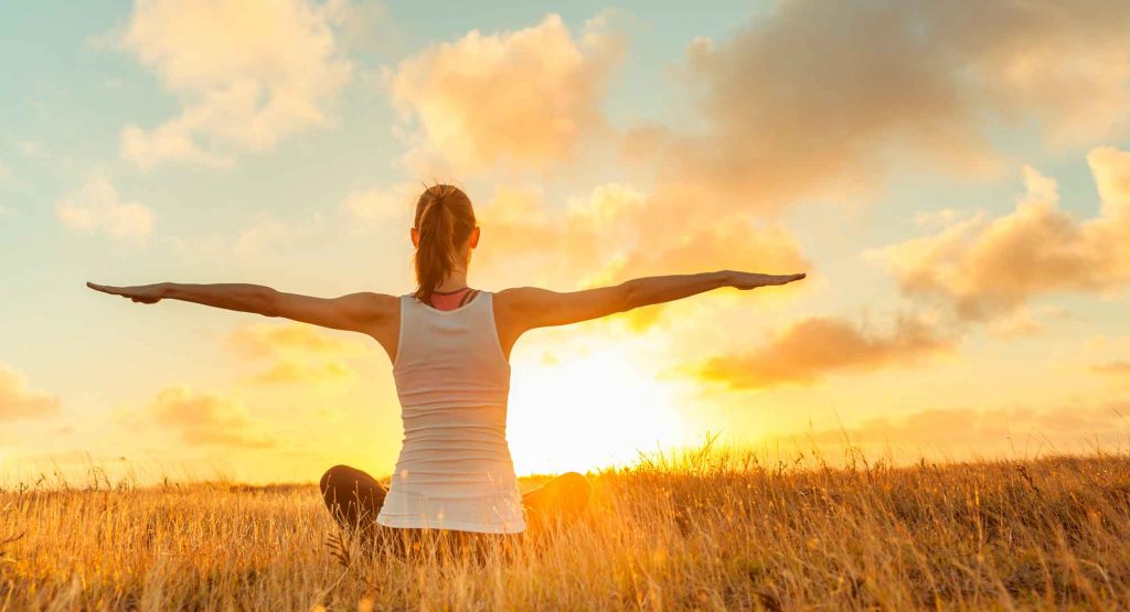 Imagen de chica practicando yoga en un campo en el Empordà